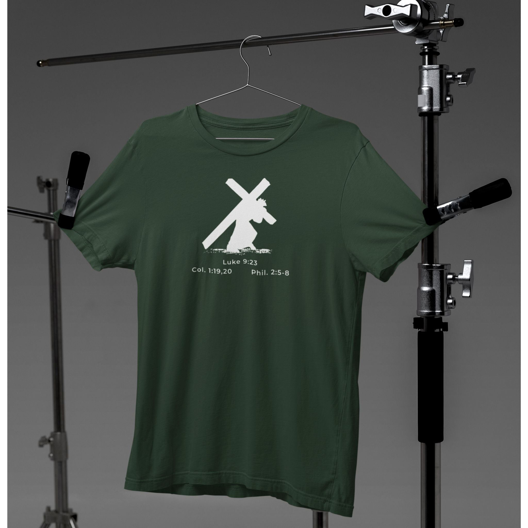 Green t-shirt with a white graphic design on a hanger against a gray background