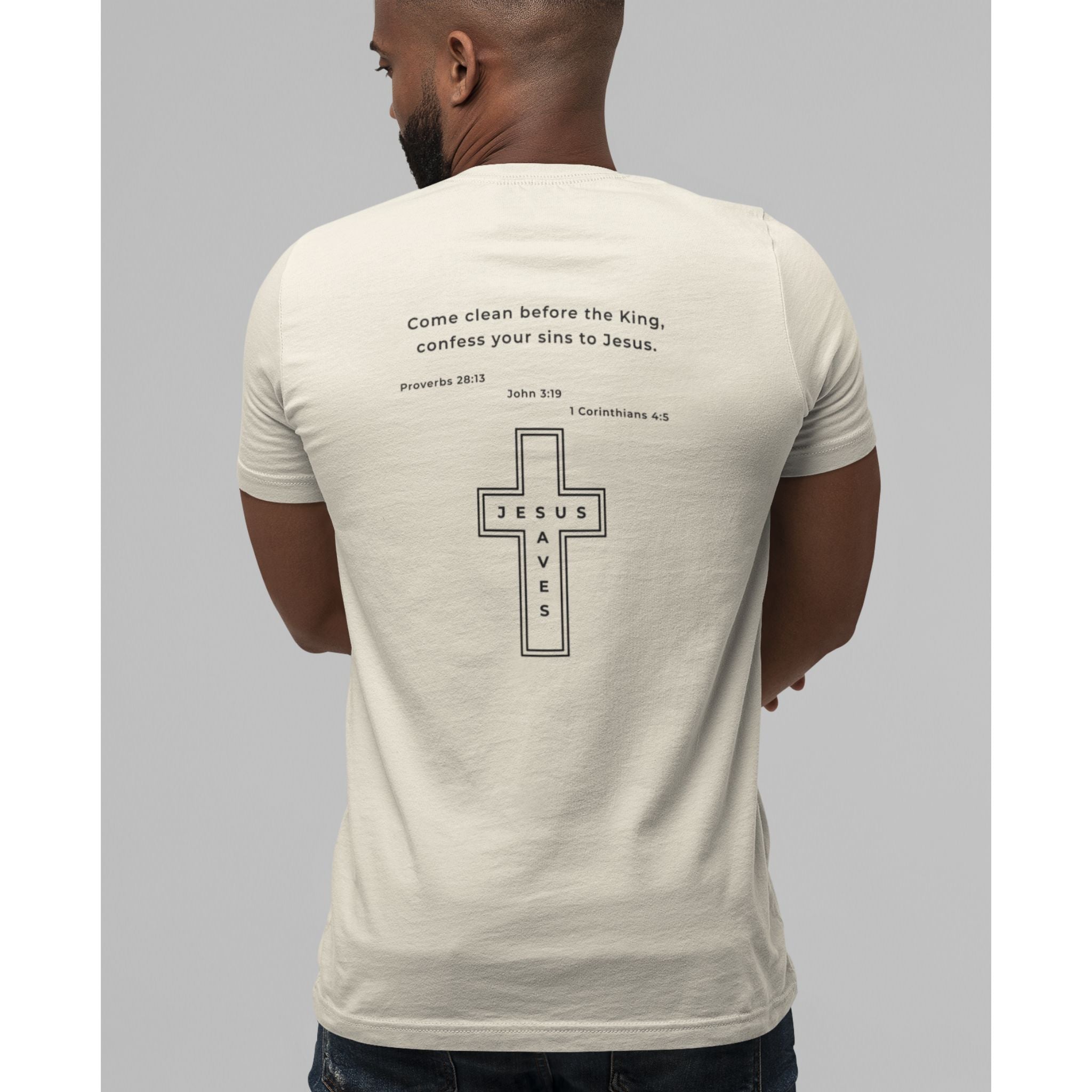 Man wearing a beige t-shirt with a cross design and text on the back, standing against a gray background.