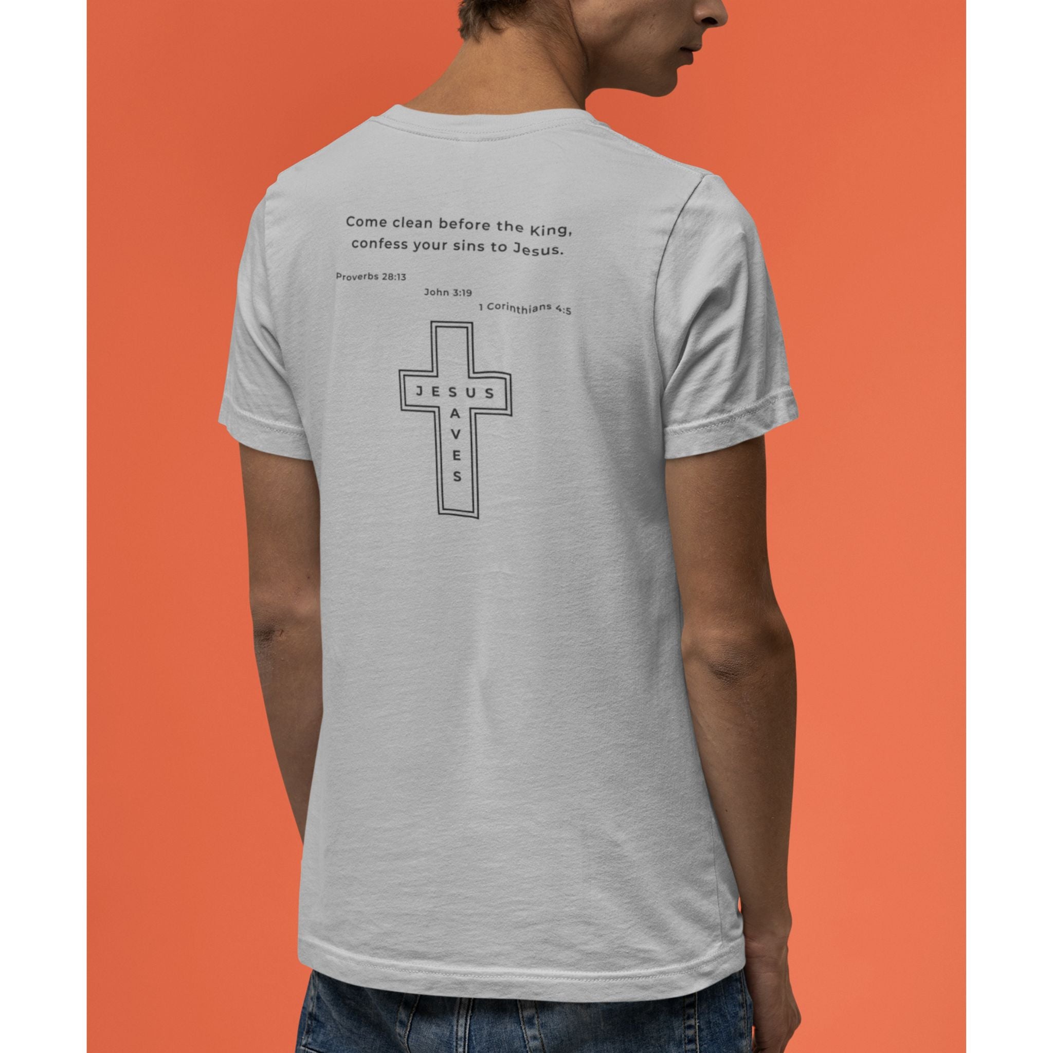 Person wearing a gray t-shirt with a cross and text on the back against an orange background