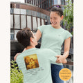 Christian t-shirt featuring an illustration of a lion, lamb, and child with the verse from Isaiah 11:6 printed on the back.