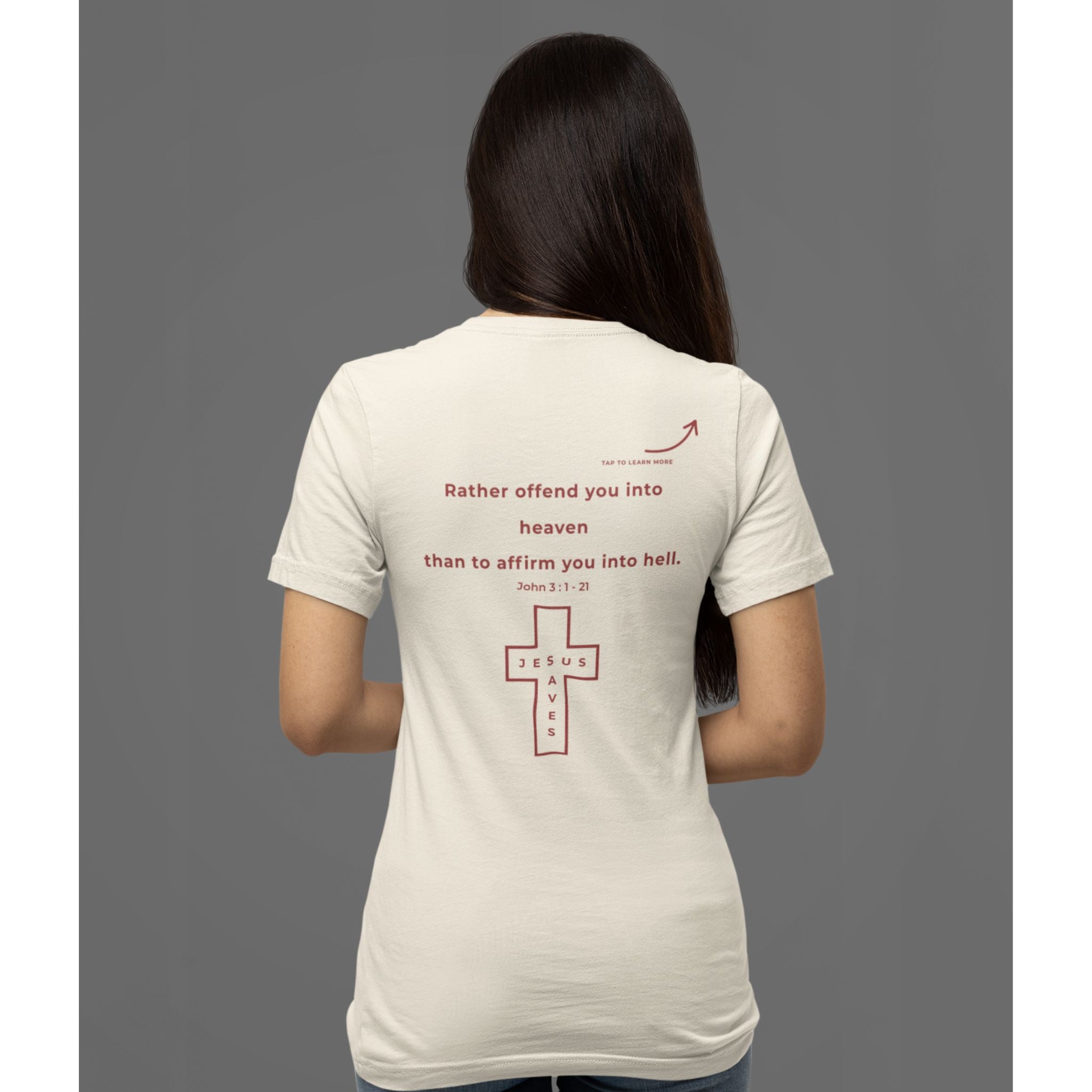 Back view of a woman wearing a natural Christian T-shirt with a red “Rather offend you into heaven than to affirm you into hell” design and cross.